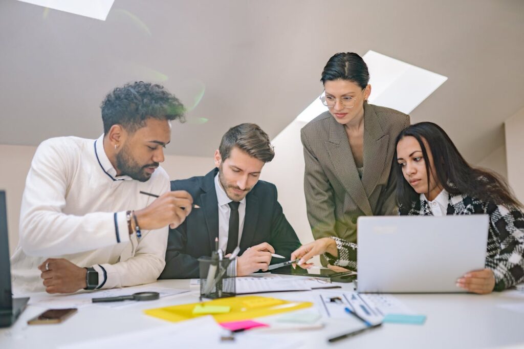 A diverse group of professionals engaged in collaborative planning in a modern office setting.